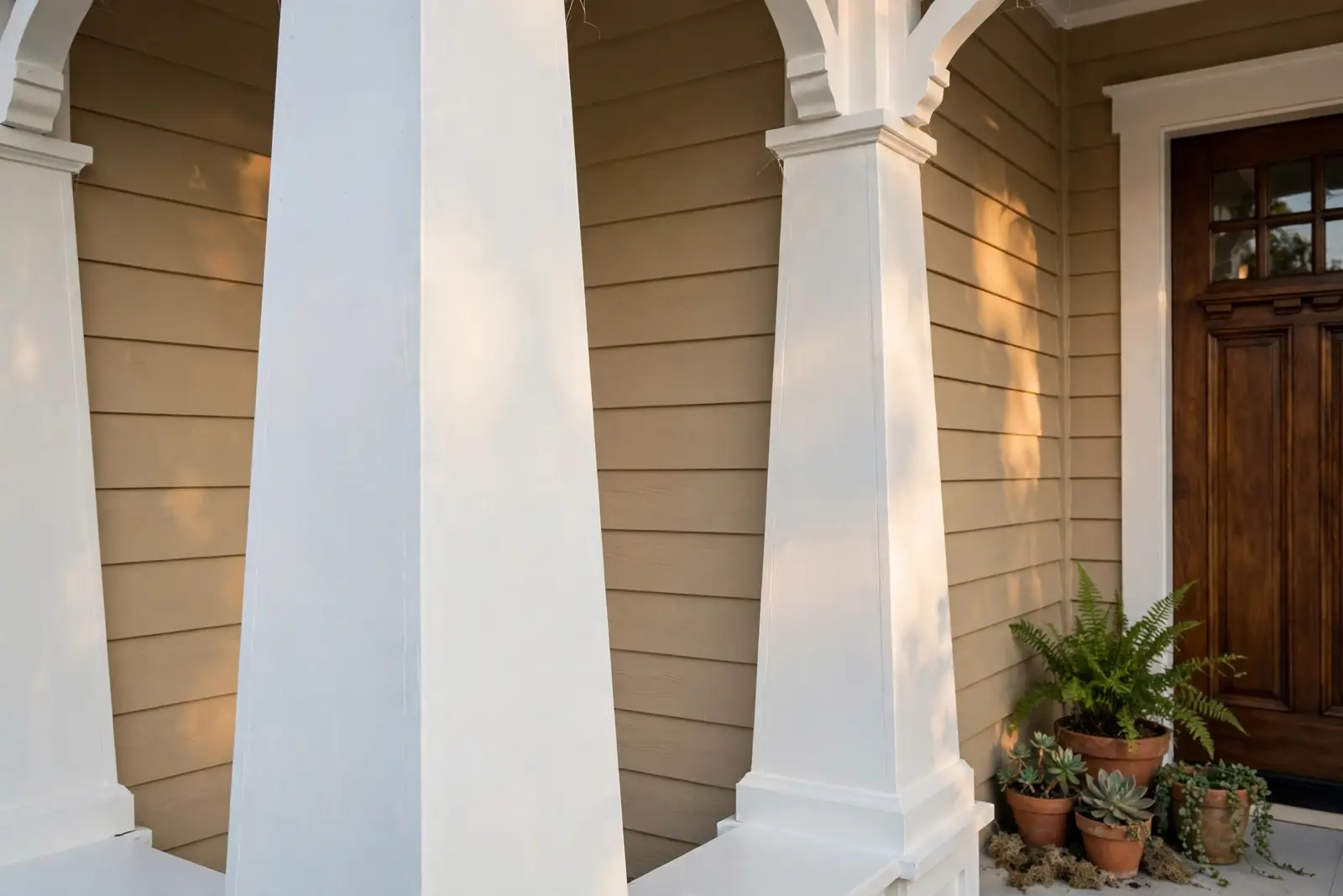 A freshly painted front porch with crisp white columns and trim